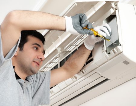 Air conditioner technician servicing indoor.